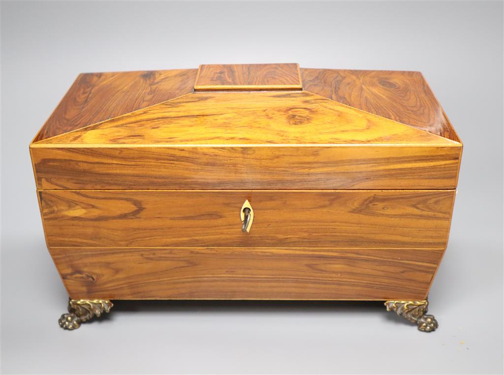 A Regency kingwood sarcophagus tea caddy fitted two containers and a cut glass bowl